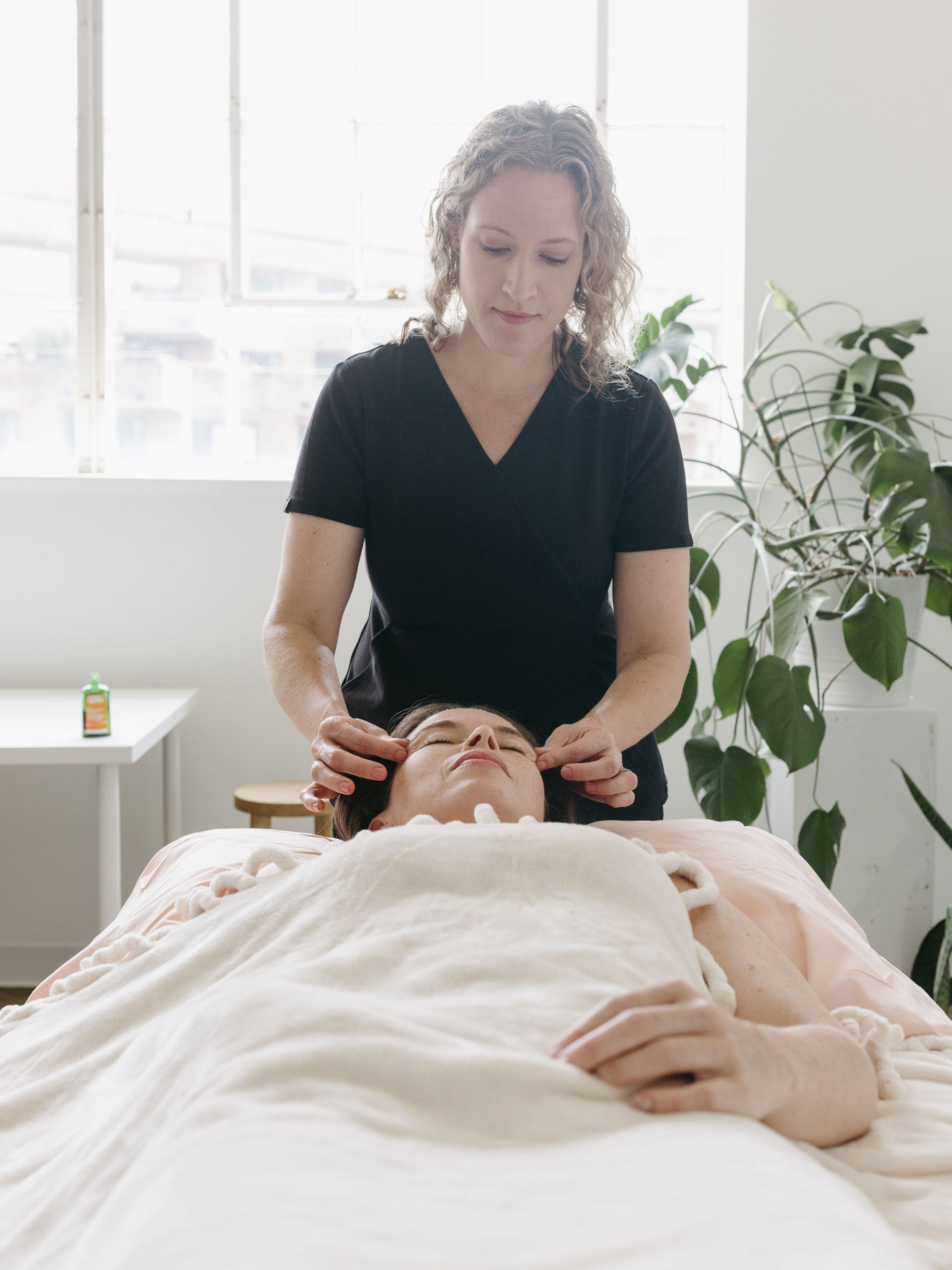 Cherry Blossom Healing Arts Acupuncture Treatment Women laying on her back getting an acupuncture treatment at Cherry Blossom Healing Arts